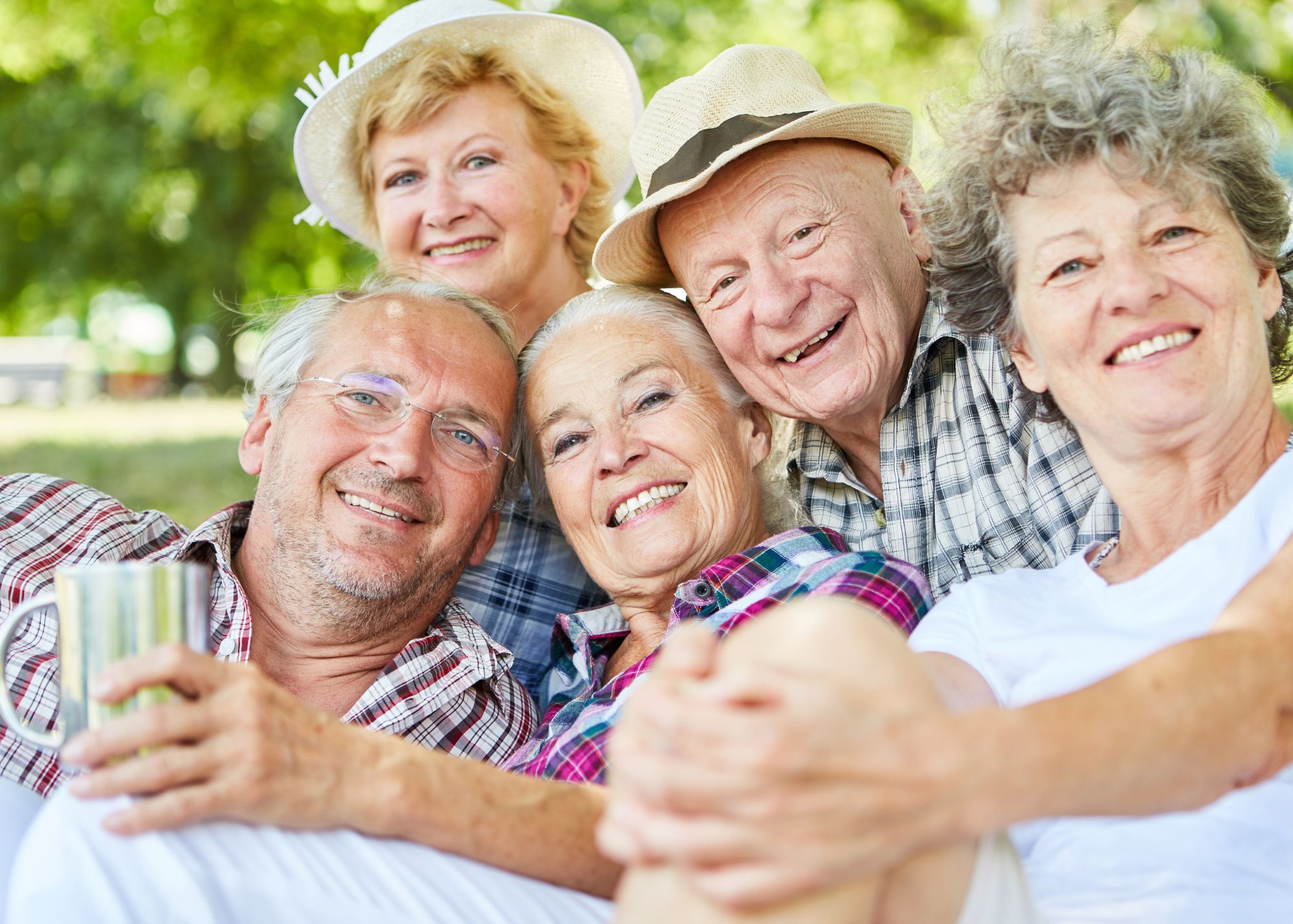 Group of 5 white elderly people smiling at the camera - Warren Real Estate Senior's Resources Page